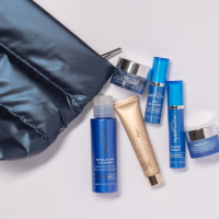 A dark blue puffy kit with 6 pieces of Hydropeptide travel sized products.